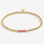 A Littles & Co Hey Mama gold bracelet featuring a delicate gold charm on a beaded band, available at Be Charmed