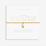 A gold chain bracelet with a crescent moon charm featuring a cat inside the moon, displayed on a white card from A Littles & Co. The card has gold foil text that reads 'A LITTLE LOVE YOU TO THE MOON AND BACK'. Available at Be Charmed