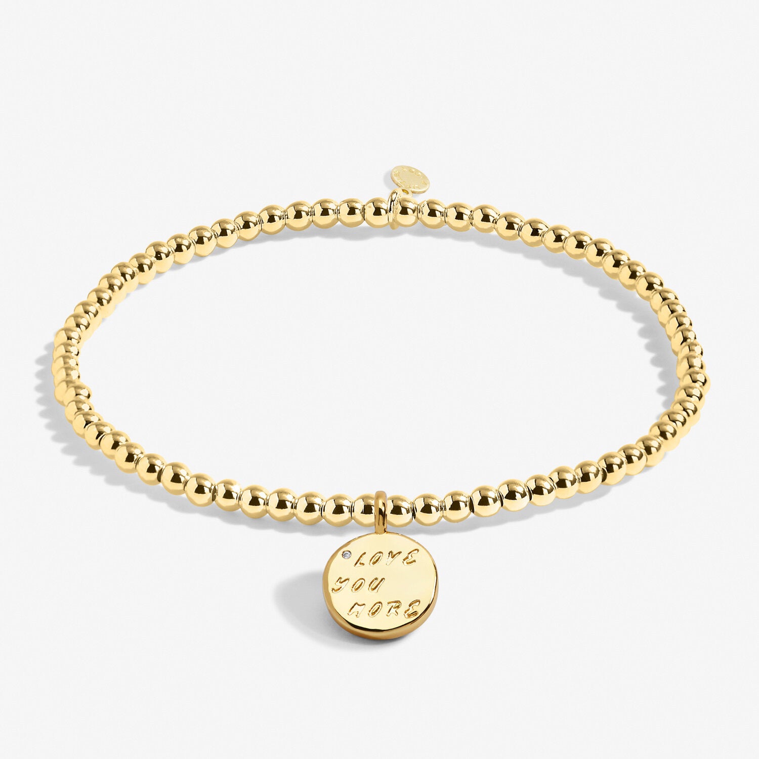 A Littles & Co Love You More gold bracelet featuring a delicate gold charm on a beaded band, available at Be Charmed