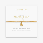 A gold chain bracelet with a small teddy bear charm and two heart charms, displayed on a white card from A Littles & Co. The card reads 'A LITTLE MAMA BEAR' and includes a sentimental message at the bottom. Available at Be Charmed