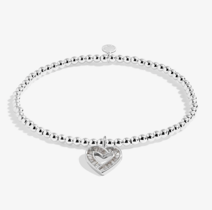 A Littles & Co Merry Christmas silver bracelet featuring a delicate silver holiday charm on a beaded band, available at Be Charmed