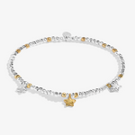 A Littles & Co Sparkle Confetti A Little Congratulations silver and gold bracelet featuring a mixed-metal charm on a delicate beaded band, available at Be Charmed
