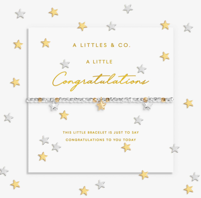 A silver and gold beaded bracelet with star charms, presented on a white card from A Littles & Co. with gold and silver star confetti scattered around the background. Available at Be Charmed