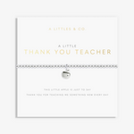 A silver beaded bracelet with a small apple charm, displayed on a white gift card from A Littlees & Co. The card features gold and gray text reading 'A LITTLE THANK YOU TEACHER' and 'THIS LITTLE APPLE IS JUST TO SAY THANK YOU FOR TEACHING ME SOMETHING NEW EVERY DAY'. Available at Be Charmed