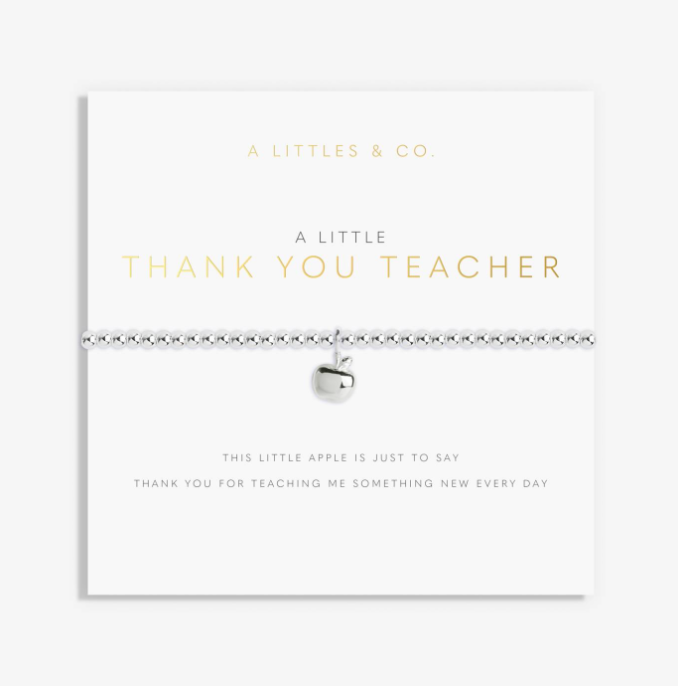 A silver beaded bracelet with a small apple charm, displayed on a white gift card from A Littlees & Co. The card features gold and gray text reading 'A LITTLE THANK YOU TEACHER' and 'THIS LITTLE APPLE IS JUST TO SAY THANK YOU FOR TEACHING ME SOMETHING NEW EVERY DAY'. Available at Be Charmed