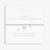 A silver beaded bracelet with a central star charm and a small embedded blue gemstone, presented on a white card from A Littles & Co. titled 'A Little Wonderful Cousin'. Available at Be Charmed