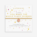 A Littles & Co You Make The Whole Place Shimmer gold bracelet featuring a delicate gold-toned charm on a beaded band, available at Be Charmed