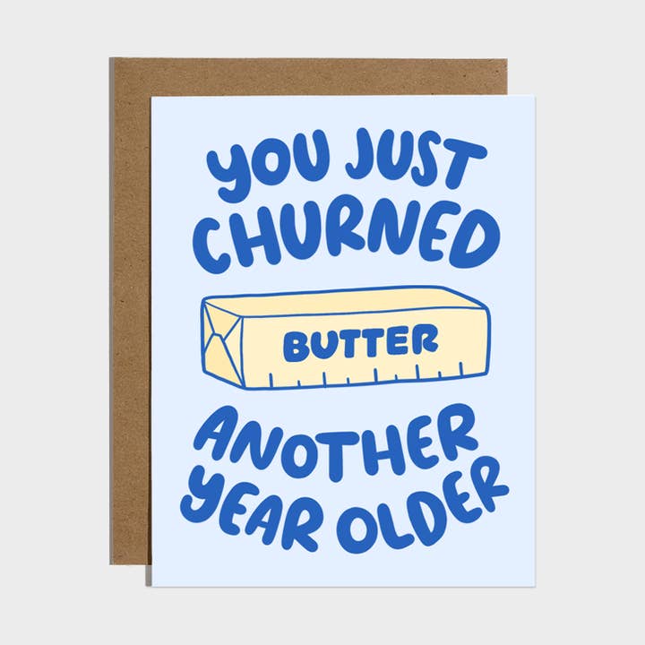 Brittany Paige birthday card featuring a stick of butter illustration and the text You Just Churned Another Year Older, available at Be Charmed