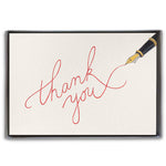 A boxed set of thank you cards with cursive writing on the front, accompanied by a cream envelope, presented in a clear slip cover. Available at Be Charmed