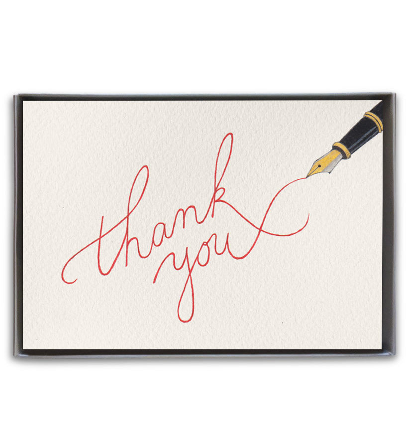 A boxed set of thank you cards with cursive writing on the front, accompanied by a cream envelope, presented in a clear slip cover. Available at Be Charmed