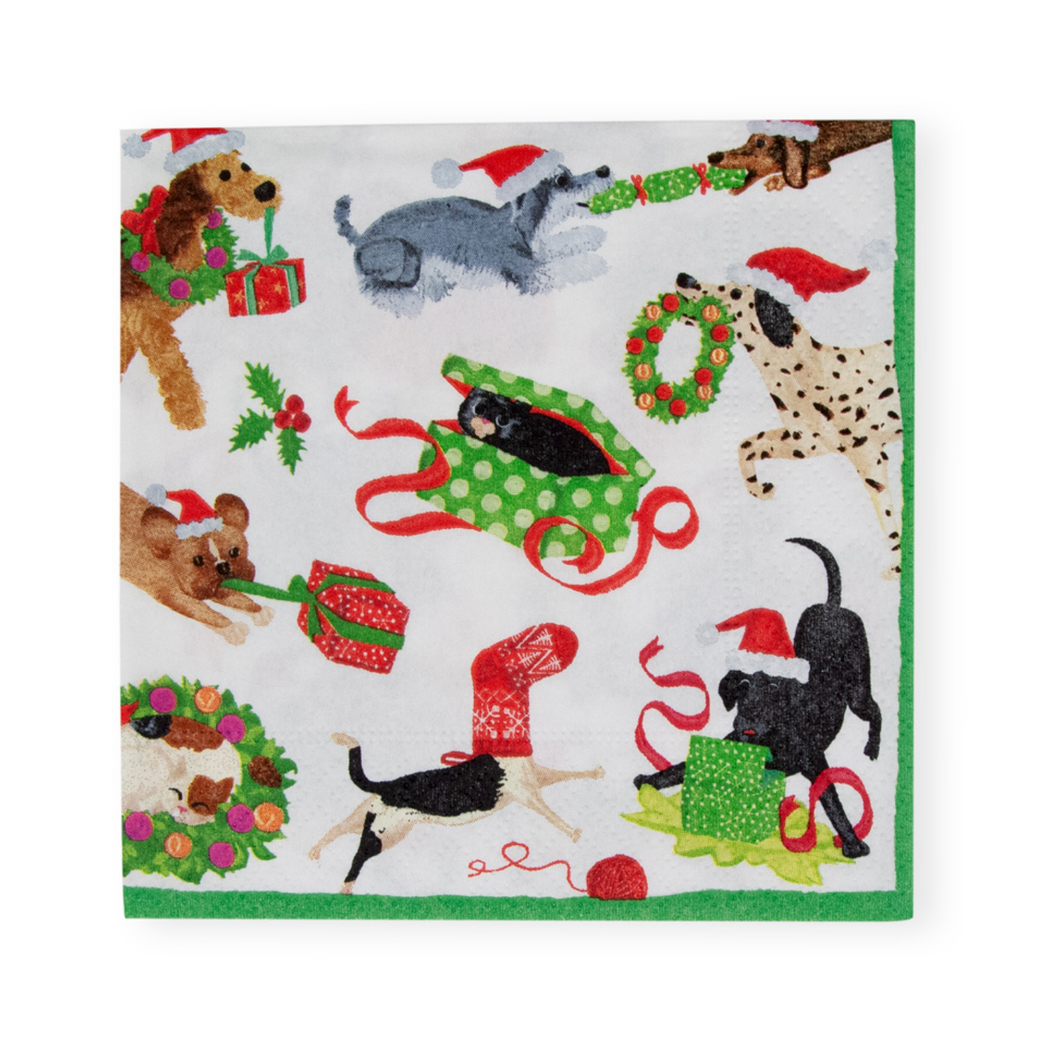 A Caspari square white napkin featuring a festive Christmas dog print with various breeds wearing Santa hats, pulling sleds, and surrounding holiday wreaths and gifts, finished with a solid green border. Available at Be Charmed