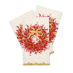 Three Christmas-themed Caspari napkins with a festive red berry wreath design, gold bow, and gold polka dots on an off-white background, arranged in a fan layout on a white studio background. Available at Be Charmed