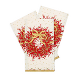 Three Christmas-themed Caspari napkins with a festive red berry wreath design, gold bow, and gold polka dots on an off-white background, arranged in a fan layout on a white studio background. Available at Be Charmed