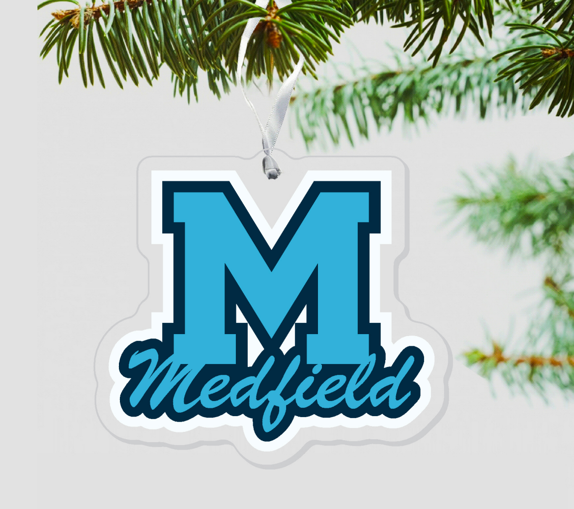 A blue and white acrylic laser cut ornament with the letter 'M' in the center, hanging from a Christmas tree with pine needles in the background. Available at Be Charmed
