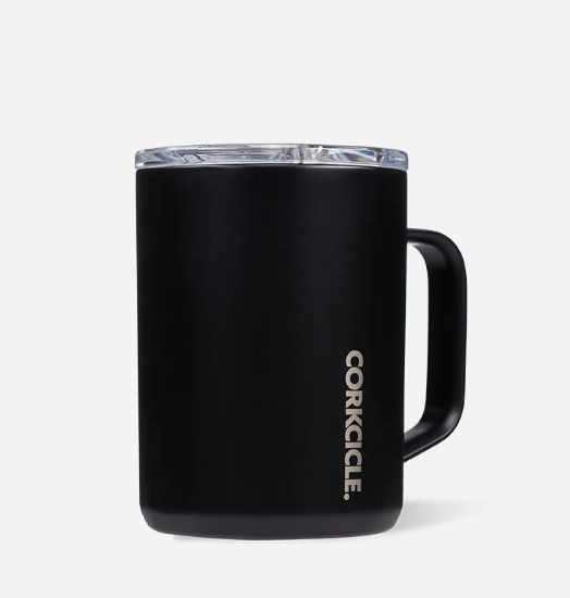 A matte black CorKicle insulated mug with a clear lid and a black handle, shown on a light gray background. Available at Be Charmed