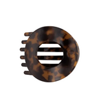 A Teleties tortoiseshell hair claw clip shown from a top-down view on a clean, off-white background. Available at Be Charmed