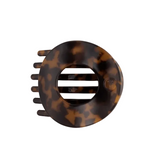 A Teleties tortoiseshell hair claw clip shown from a top-down view on a clean, off-white background. Available at Be Charmed