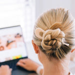 Person with a stylish hair bun using a Teleties french pin.