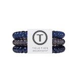 Three Teleties hair stretch bands in navy blue and clear patterned material, wrapped around a white paper band with the Teleties logo and name. Avaialbe at Be Chamred