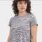 Person wearing a gray zebra pattern t-shirt on a white background. Available at be Charmed