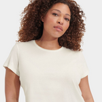 Woman wearing a white t-shirt against a plain background. Available at Be Charmed