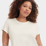 Woman wearing a white t-shirt against a plain background. Available at Be Charmed