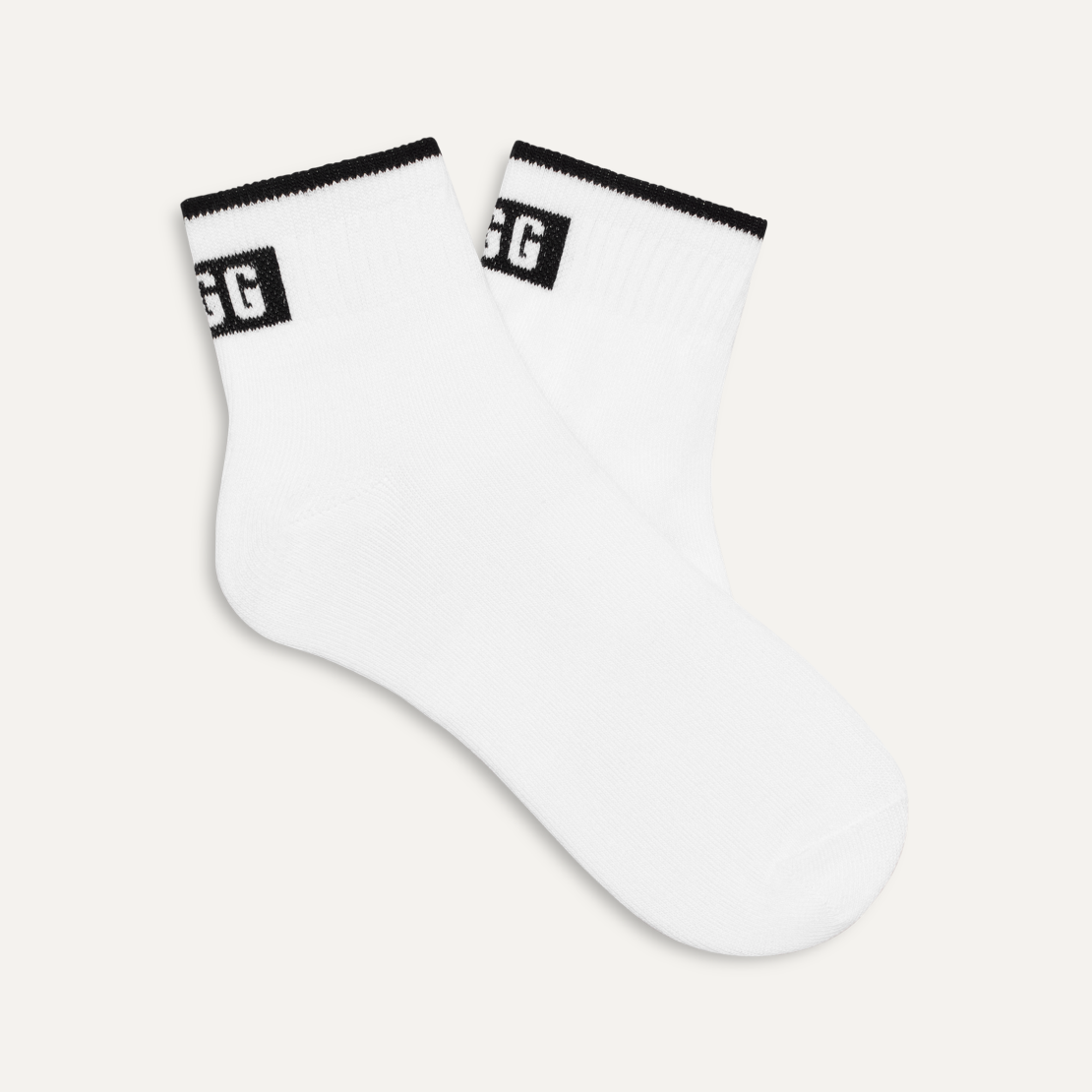 A pair of white UGG Polly ankle socks with black detailing around the ankle area. Available at Be Charmed