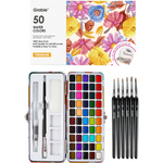 Grabie 50 Water Colors paint set shown open with a full array of 50 color pans, two brushes inside the case, and five black-handled paintbrushes beside it on a white background. Available at Be Charmed
