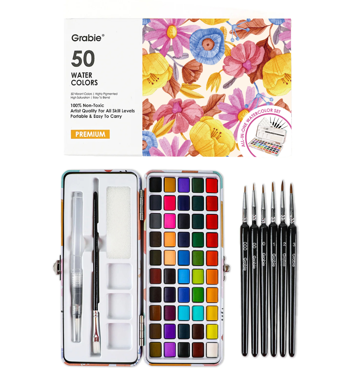 Grabie 50 Water Colors paint set shown open with a full array of 50 color pans, two brushes inside the case, and five black-handled paintbrushes beside it on a white background. Available at Be Charmed