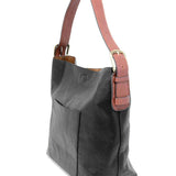 Black shoulder bag with brown strap on a white background. Available at Be Charmed