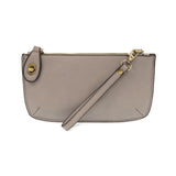 Joy Susan Gray wristlet purse with a strap on a white background. Available at Be Charmed