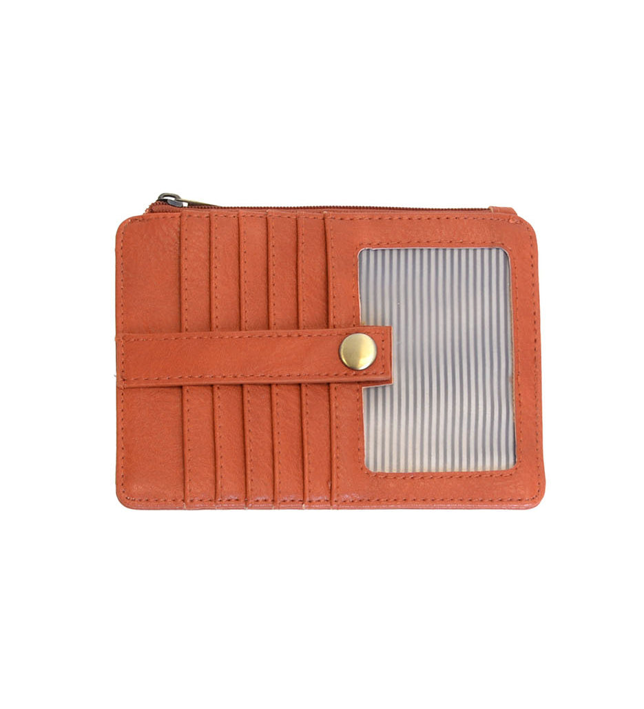 An Joy Susan bonfire orange card holder wallet with multiple card slots, a horizontal strap with a gold snap button, and a clear window showing striped cards inside, set against a plain white background. Available at Be Charmed