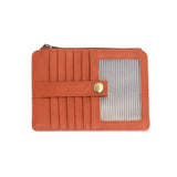 An Joy Susan bonfire orange card holder wallet with multiple card slots, a horizontal strap with a gold snap button, and a clear window showing striped cards inside, set against a plain white background. Available at Be Charmed