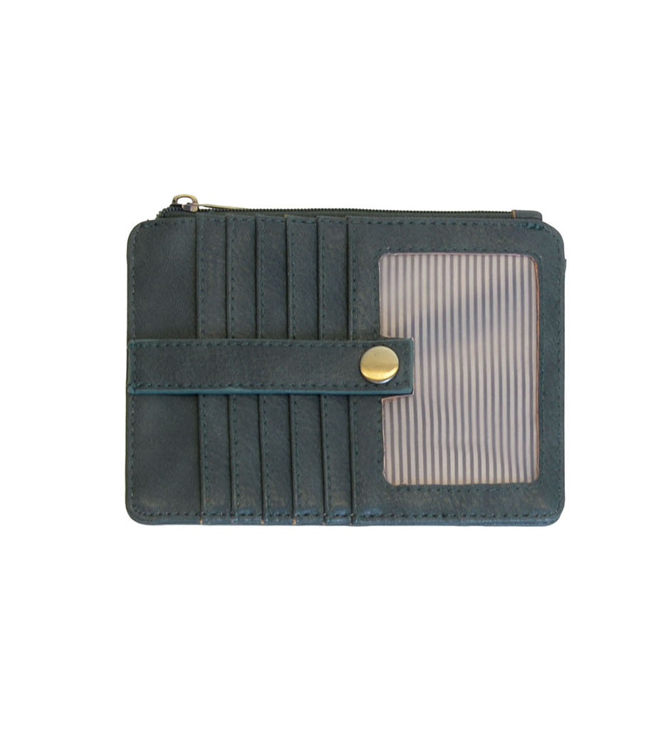 A Joy Susan castleton green card holder wallet with multiple card slots, a horizontal strap with a gold snap button, and a clear ID window on the right side, shown against a plain white background. Available at Be Charmed