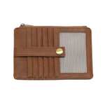 A Joy Susan pecan card holder wallet with multiple card slots, a horizontal strap with a gold snap button, and a clear striped ID window on the front, shown against a plain white background. Available at Be Charmed