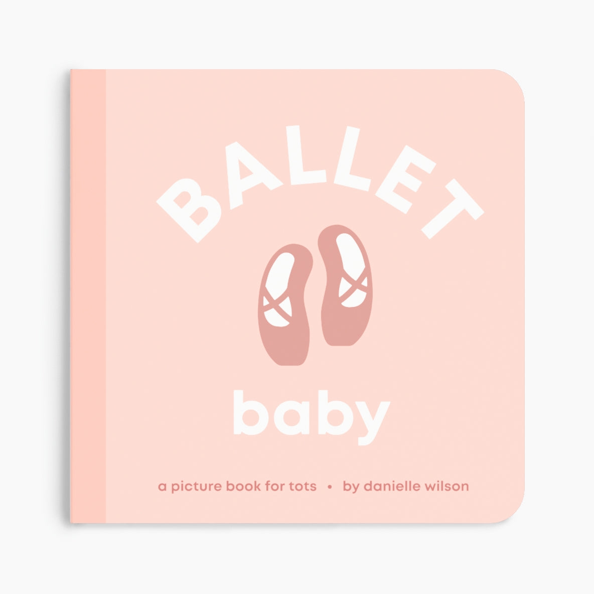 A baby picture book titled 'Ballet baby' by Danielle Wilson, featuring a soft pink cover with white text and a central illustration of ballet shoes. Available at Be Charmed