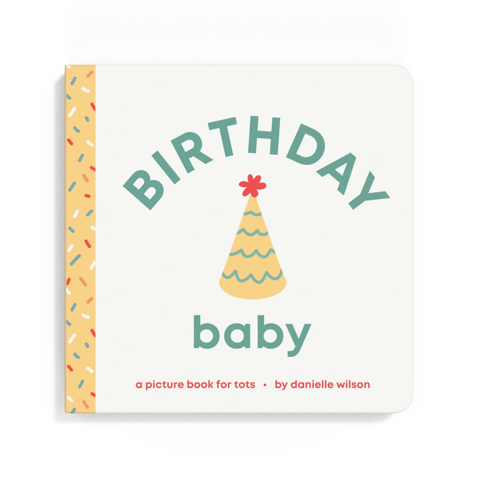 A baby picture book titled 'BIRTHDAY baby' by Danielle Wilson, featuring a cream-colored cover with a yellow party hat illustration and a yellow spine decorated with multicolored sprinkles. Available at Be Charmed