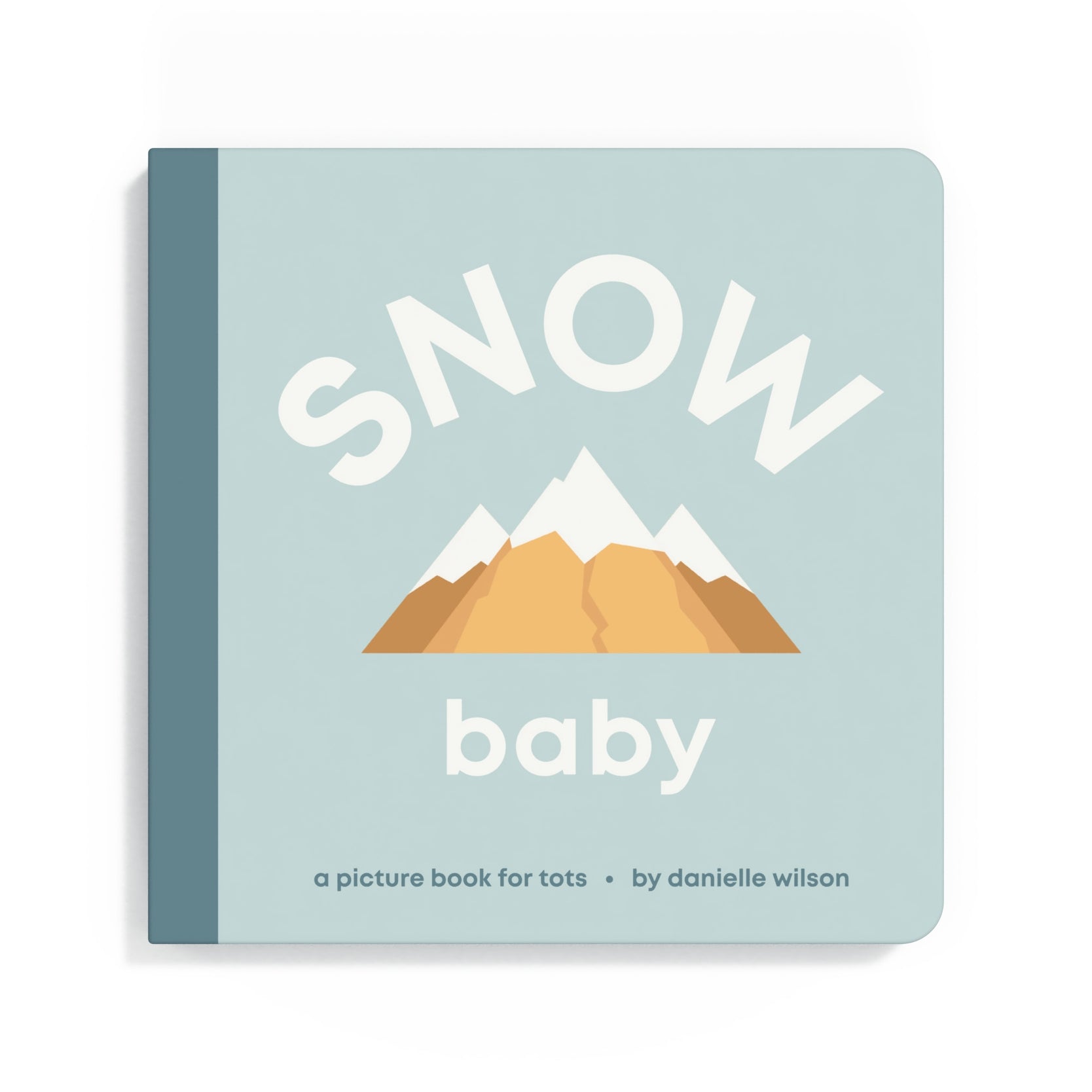 Book titled 'Snow Baby' with mountain illustration on a light blue background. Available at Be Charmed