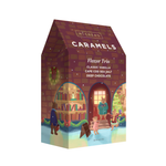 McCrea's Caramels Flavor Trio chocolate box with a whimsical winter library illustration on the front, featuring bear characters and holiday decorations. Available at Be Charmed
