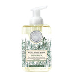 Michel Design Works foaming hand soap bottle with evergreen design on a white background. Available at Be Charmed