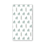 A rectangular napkin featuring a repeating pattern of small evergreen trees in muted green and gray tones, shown against a plain white background. Available at Be Charmed