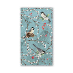 Napkin with bird and branch design on a blue background. Available at Be Charmed