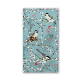 Napkin with bird and branch design on a blue background. Available at Be Charmed