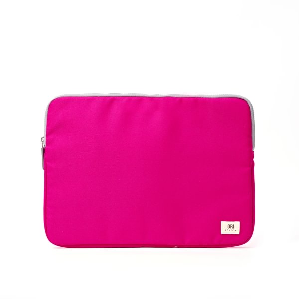 A bright pink Ori fabric laptop sleeve with a silver zipper and a small white brand label in the bottom right corner, shown against a plain white background. Available at Be Charmed