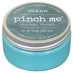 Blue container of 'pinch me' therapy dough with ocean scent on a white background. Available at Be Charmed