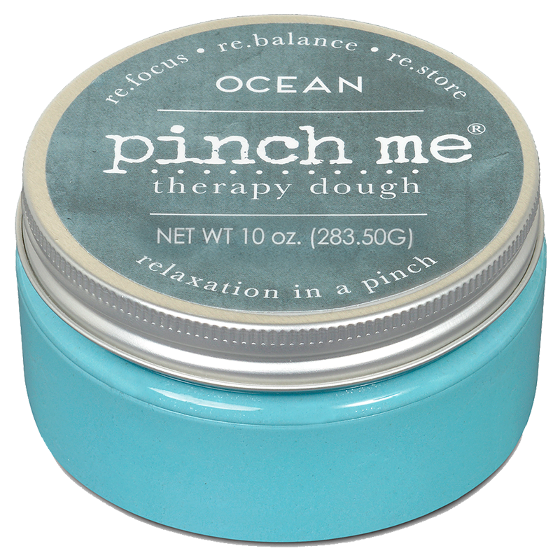Blue container of 'pinch me' therapy dough with ocean scent on a white background. Available at Be Charmed