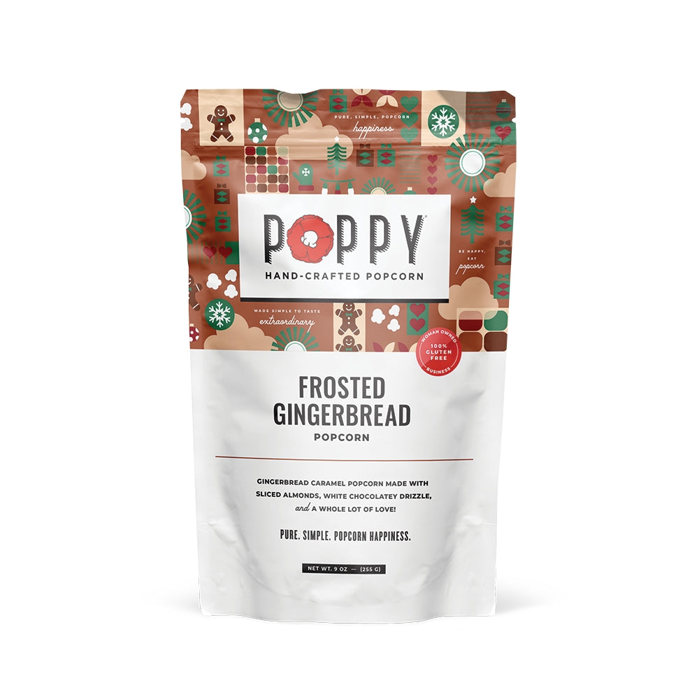 A stand-up pouch of Poppy Hand-Crafted Popcorn in the Frosted Gingerbread flavor, featuring a festive gingerbread-themed pattern on the upper half and white lower half with black text. Available at Be Charmed