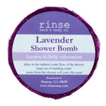 A circular blue shower bomb packaging with a label that reads 'Lavender Shower Bomb' from Rinse Bath & Body  Co. Available at Be Charmed