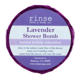 A circular blue shower bomb packaging with a label that reads 'Lavender Shower Bomb' from Rinse Bath & Body  Co. Available at Be Charmed