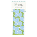 A packaged kitchen tea towel with a light blue and green hydrangea pattern, shown on a white background with a branded header card. Available at Be Charmed